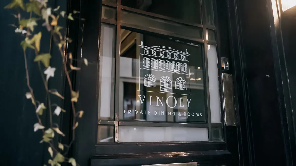 The entrance door, its glass etched with the Vinoly logo and the words private dining and rooms